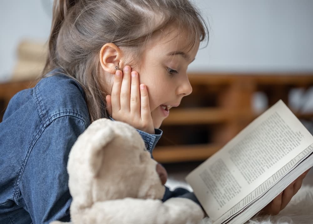 A child with ADHD practicing reading aloud to improve focus.