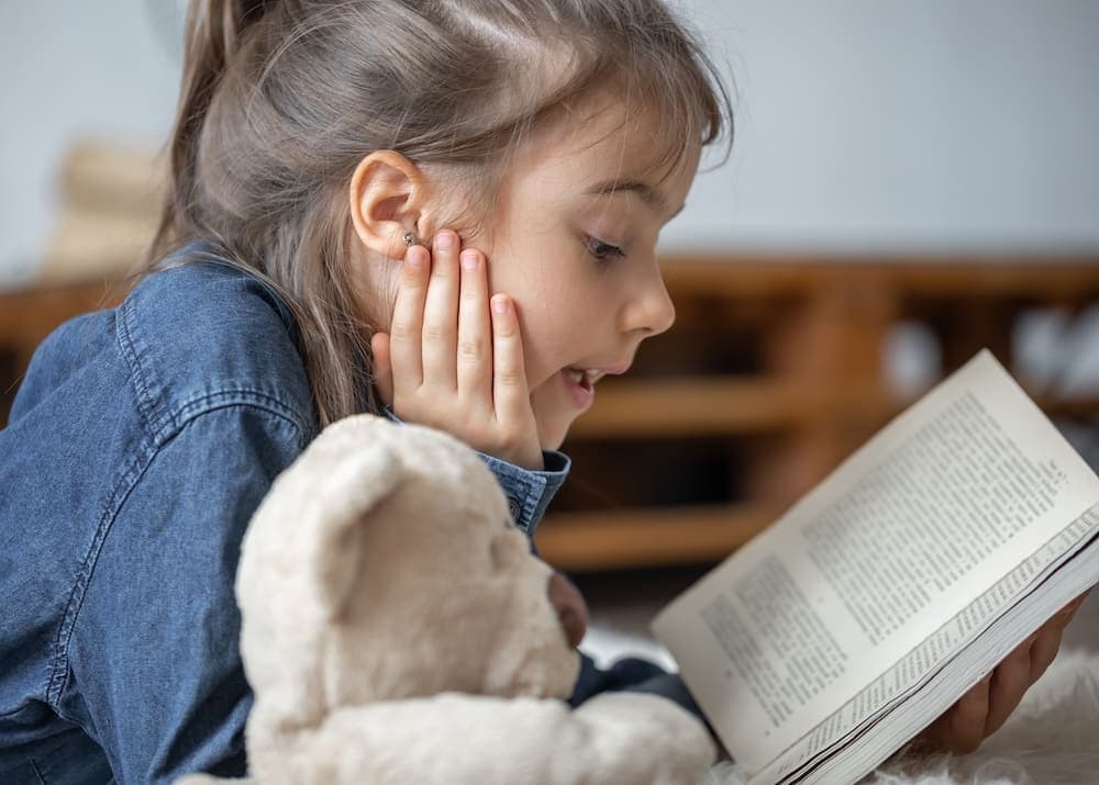 A child with ADHD practicing reading aloud to improve focus.